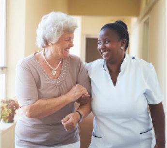 Caregiver helping a senior woman at home