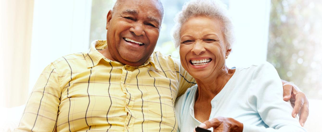 Senior couple laughing together at home