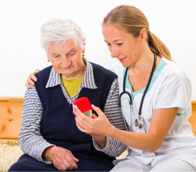 Caregiver sharing an activity with a senior man